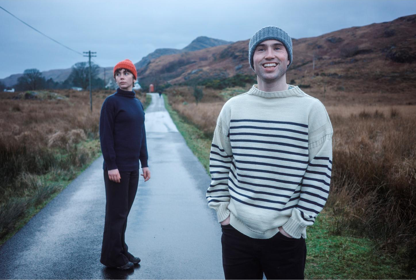 Male and female wearing British Woollens Breton and Submariner on a mountain road 